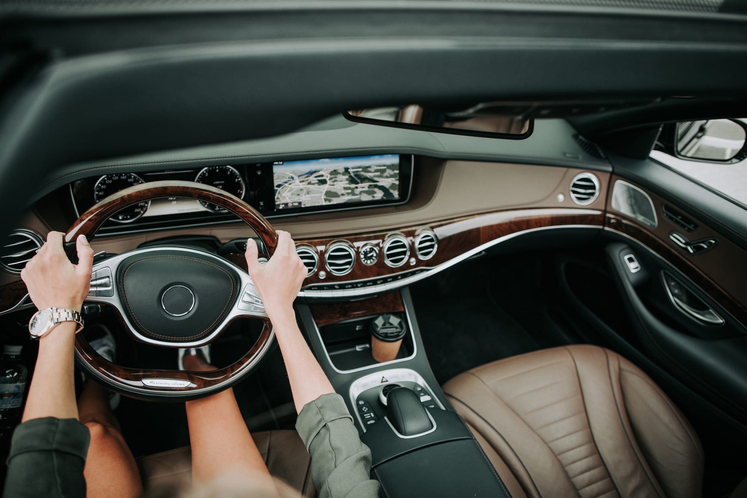 Girl hands holding steering wheel of automobile
