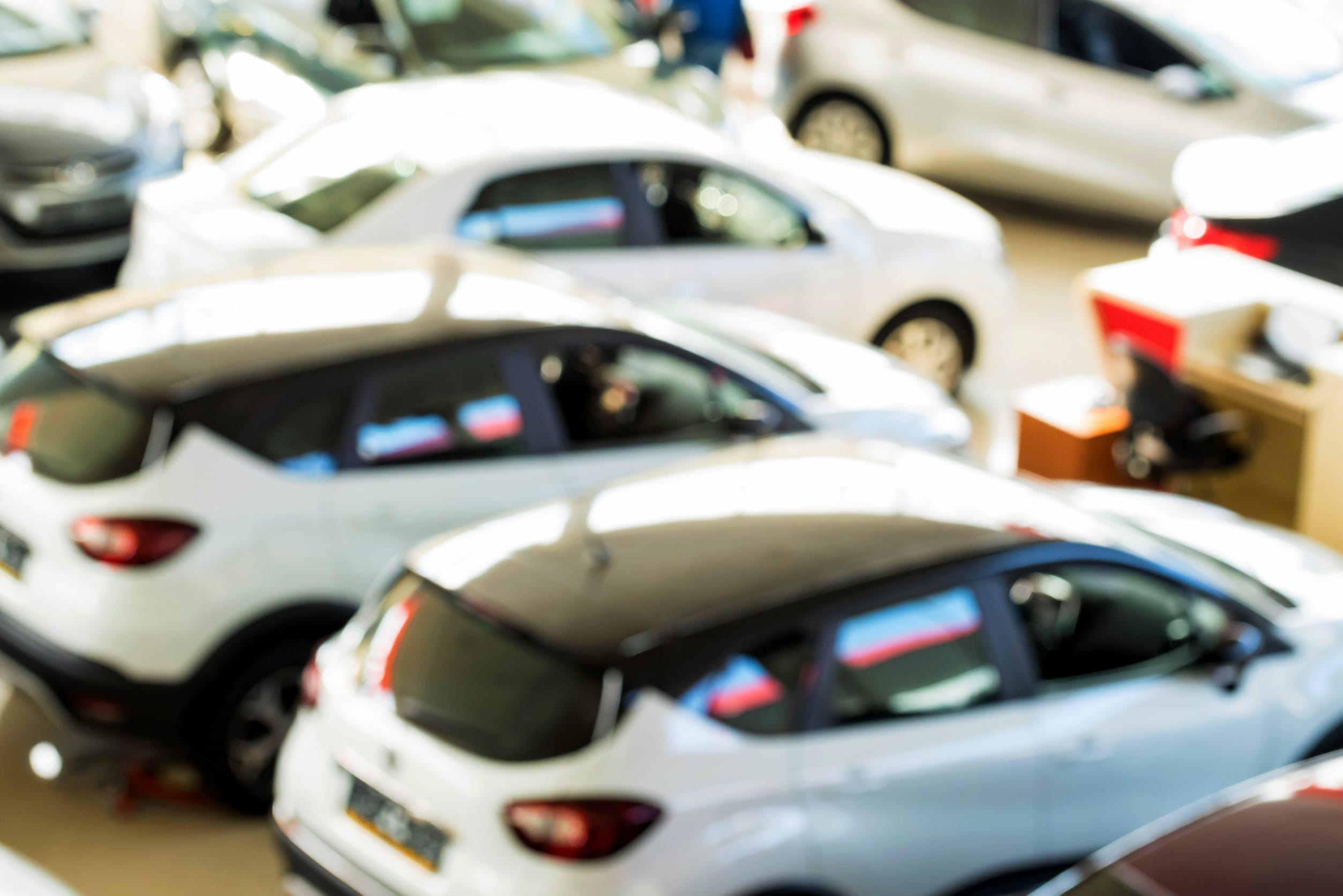 New cars at dealer showroom blurred interior