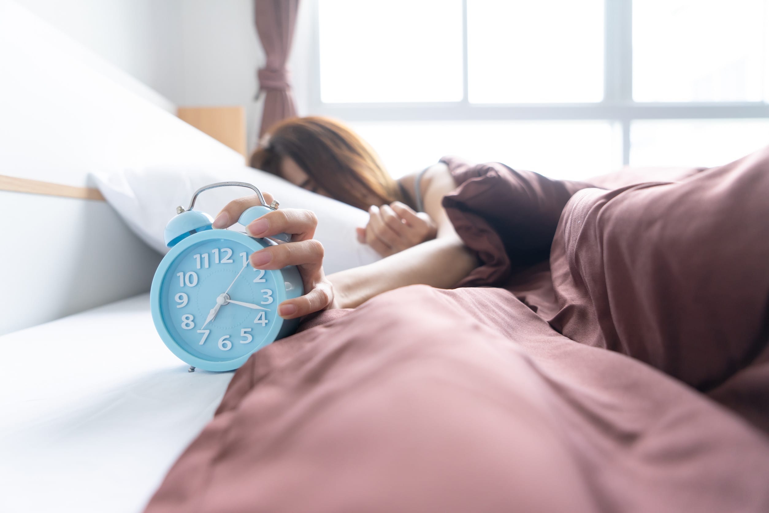 A woman waking up early, which is a healthy habit that makes you miserable