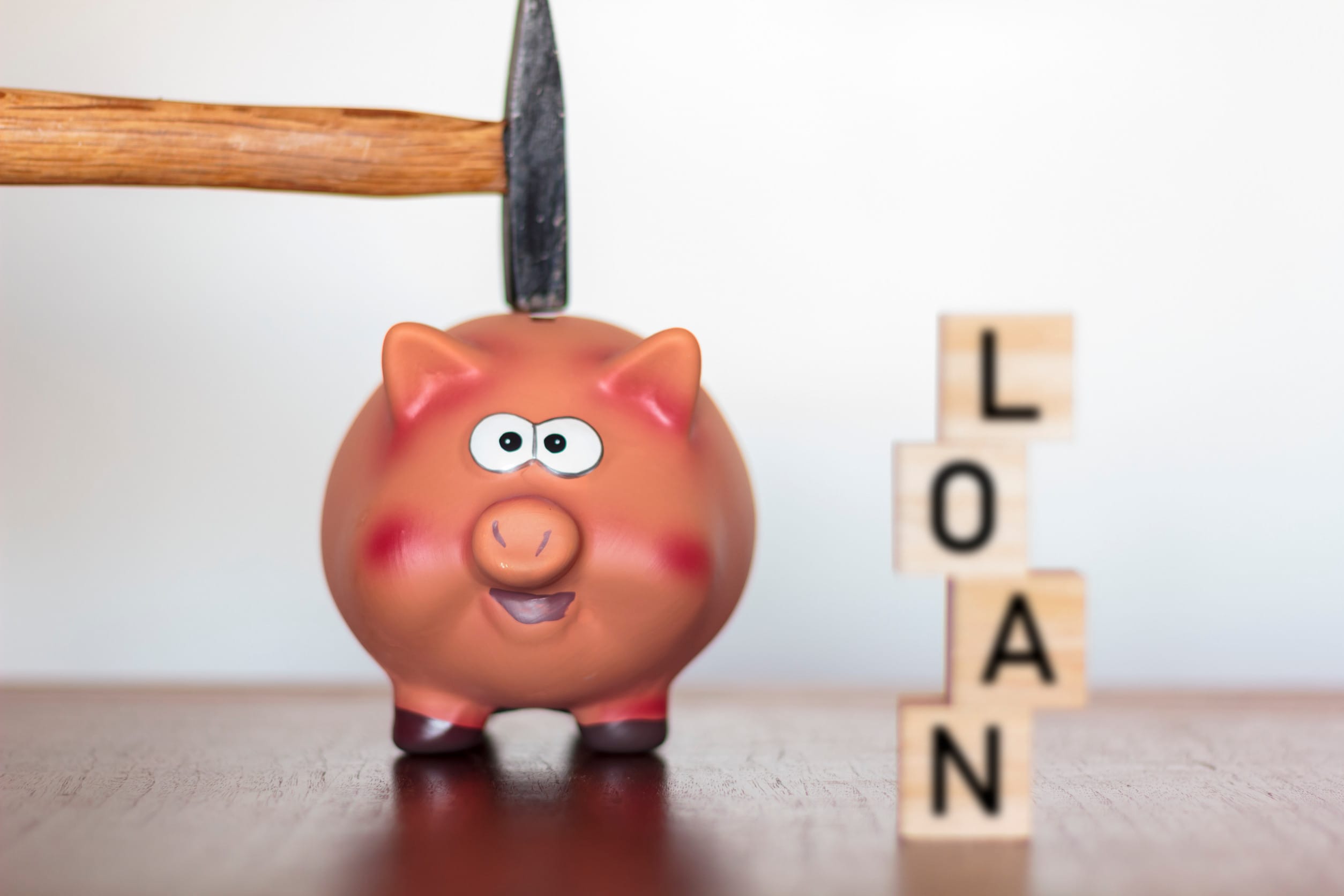 About to smash a piggy bank to get a loan, which can affect and wreck families