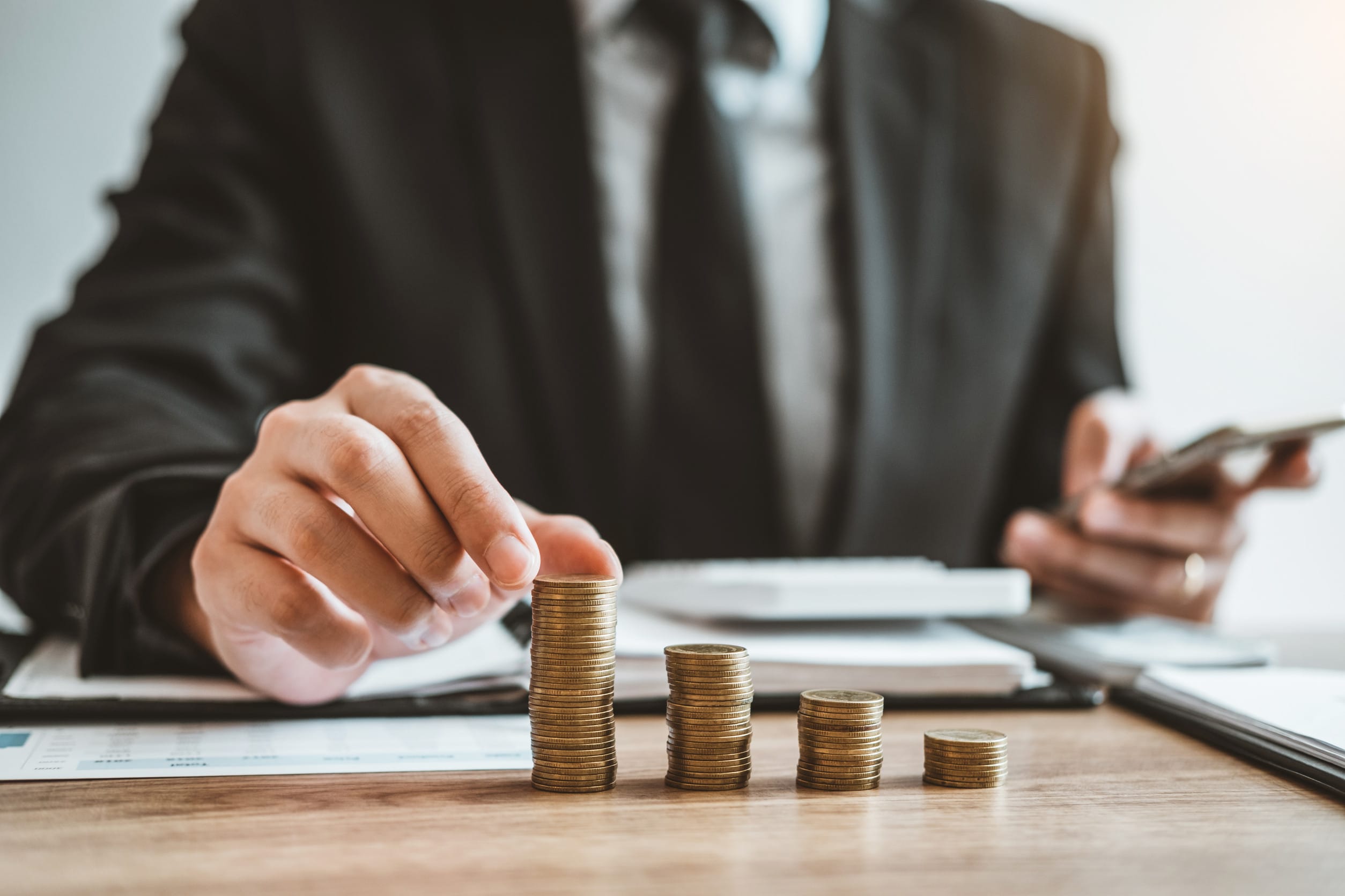 A man stacking coins, symbolizing his focus on personal finance