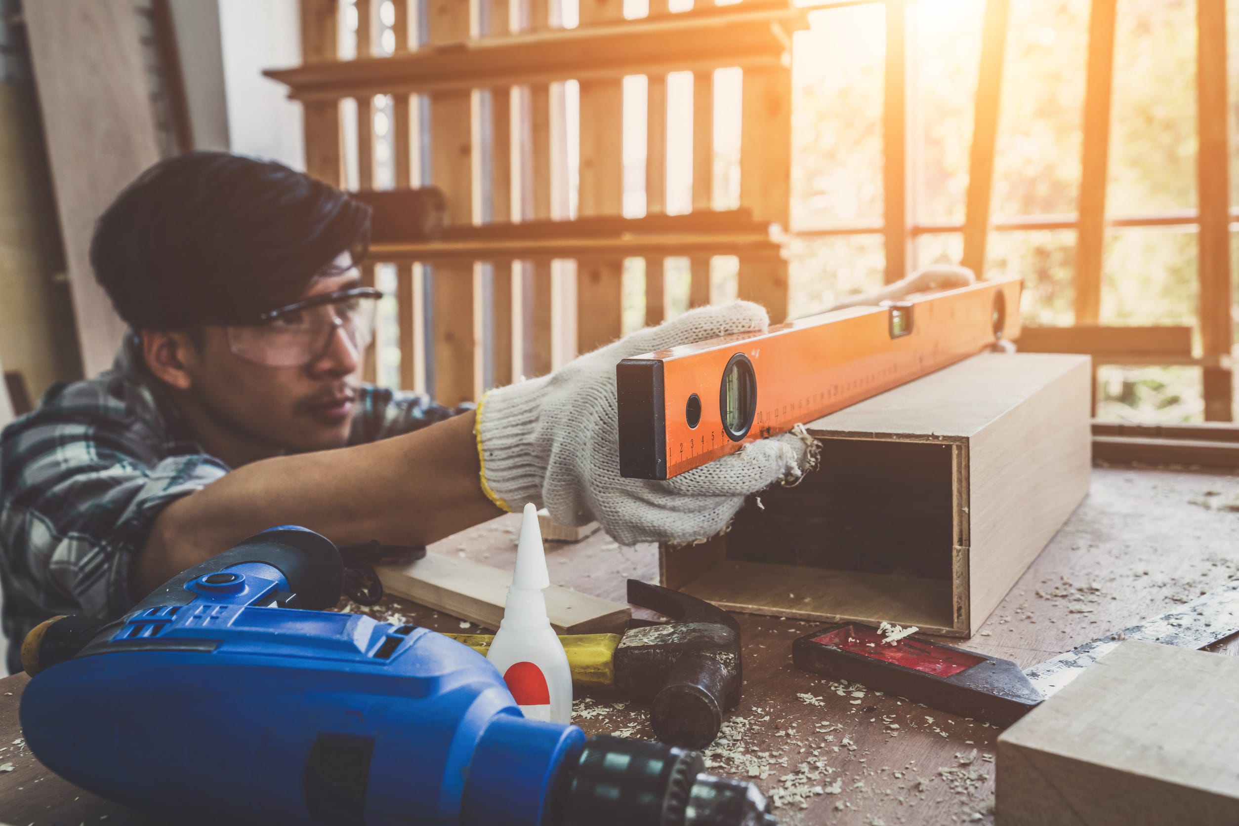Carpenter working on wood craft at workshop