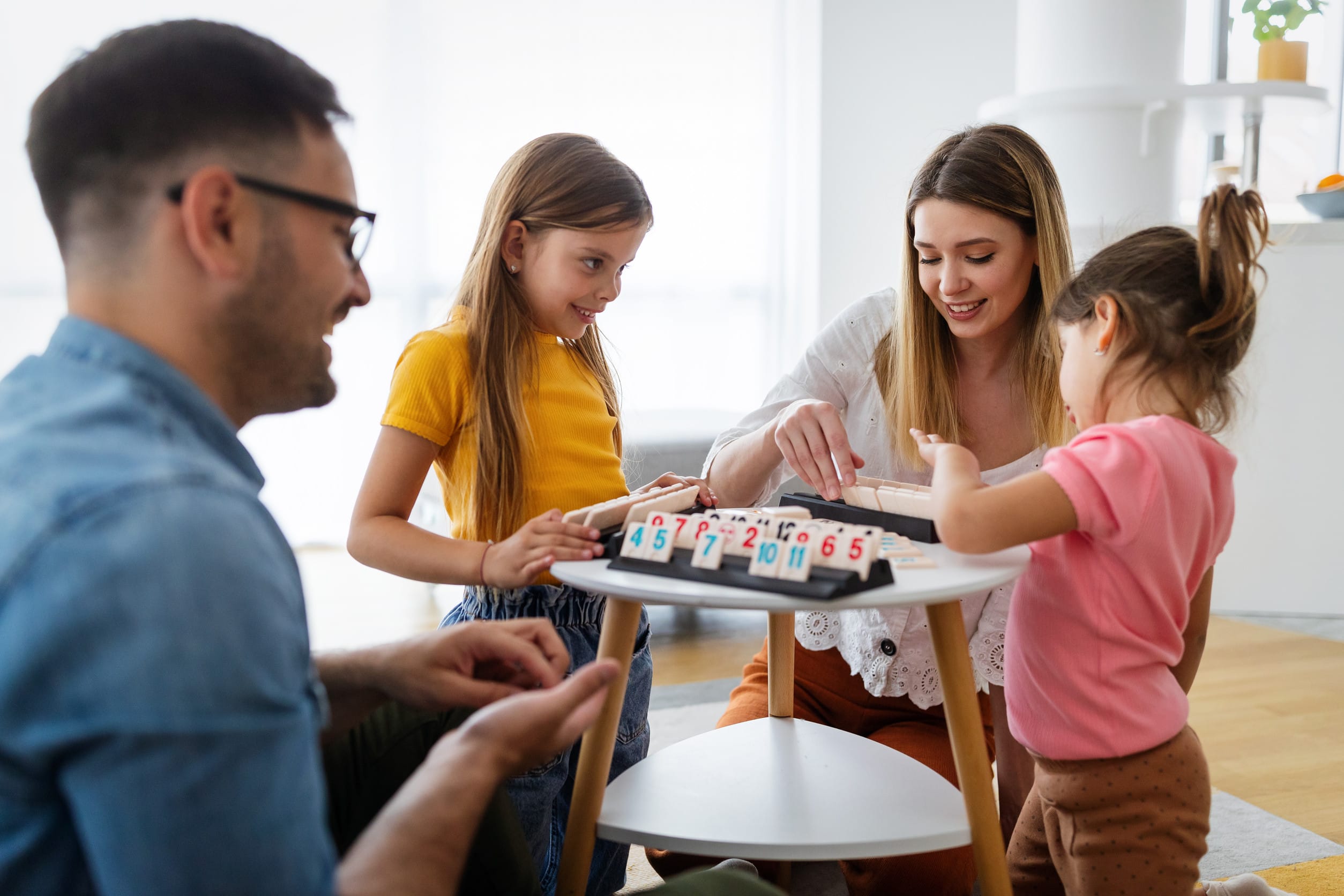 A family participating in game night, which is a chance for children to learn valuable life lessons