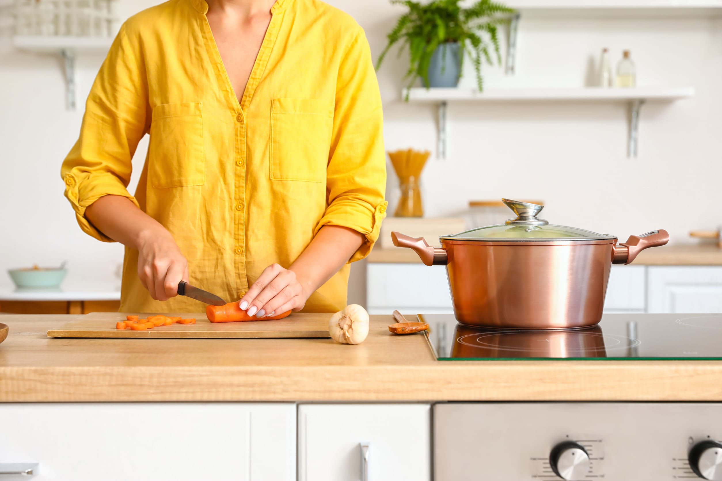 A Baby Boomer making a meal at home, a smart financial habit that saves money