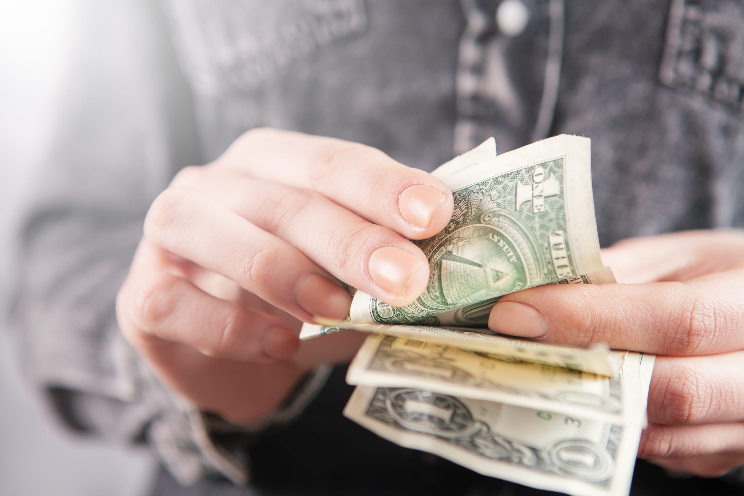 Someone counting the small amount of money they have