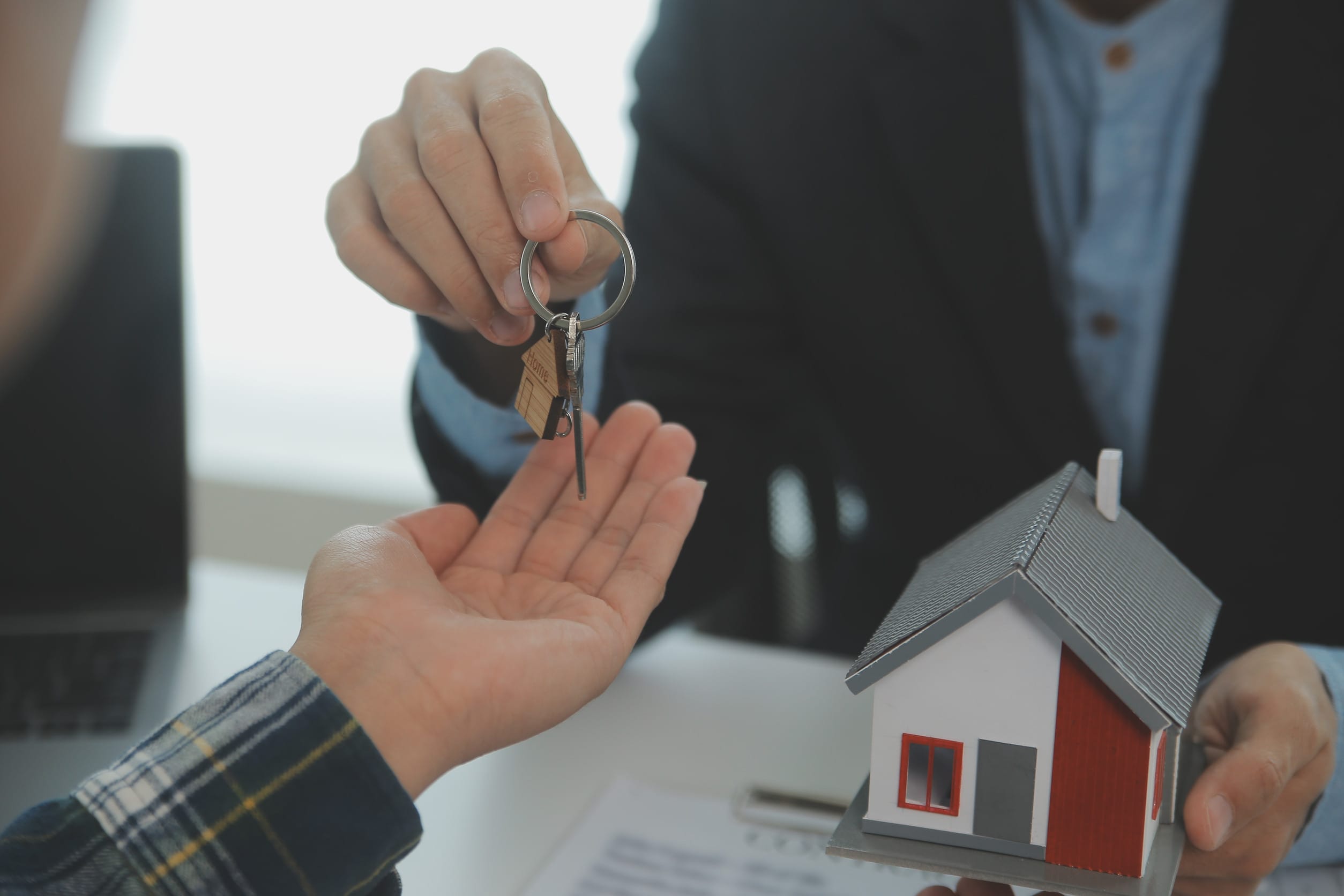 Someone selling a house and handing the keys over to the new owner