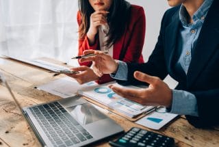 A wealthy person being talked to by a financial advisor