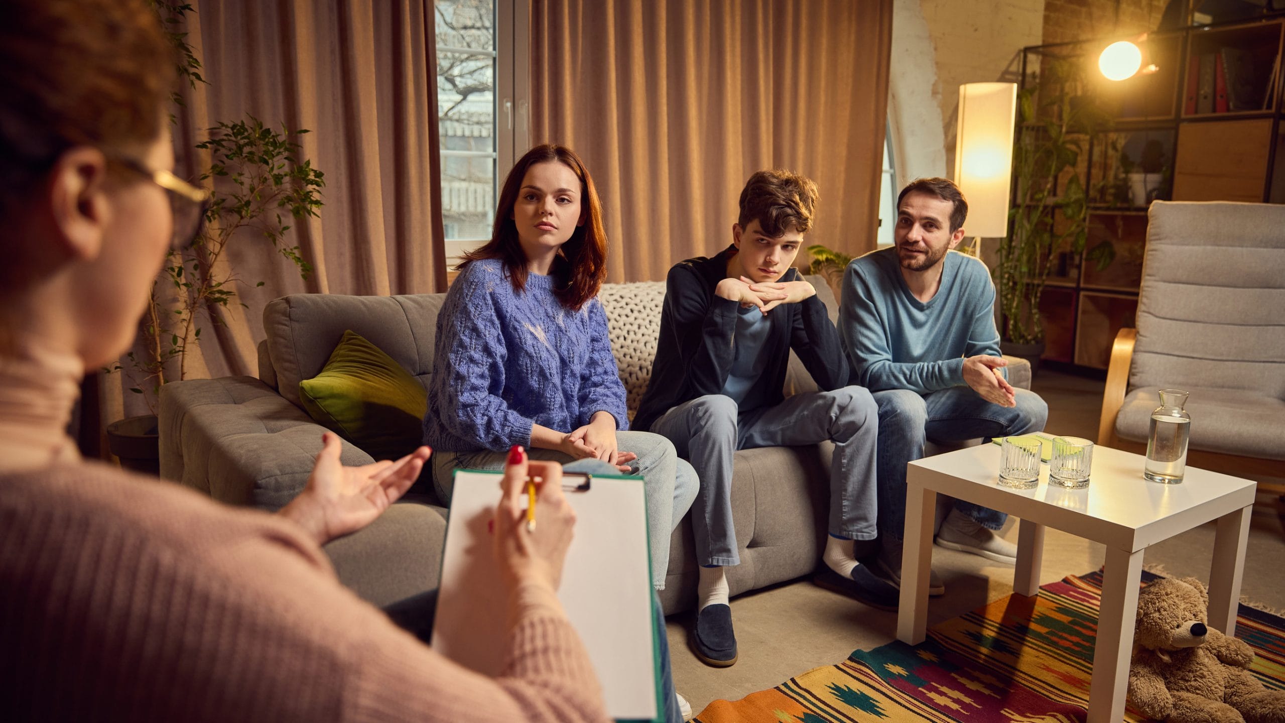 A son and his parents in family therapy together