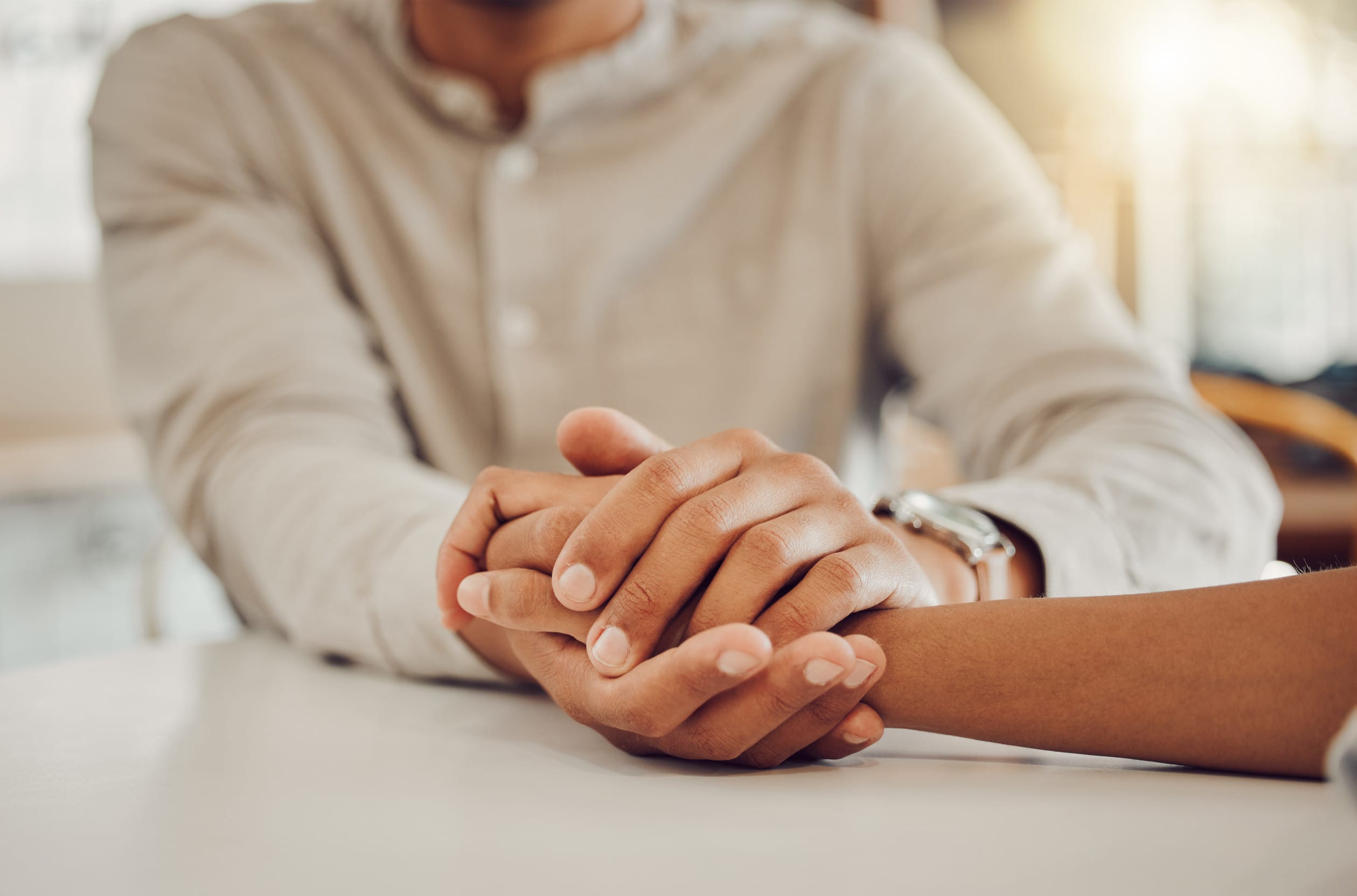 Two people in a relationship with clasped hands