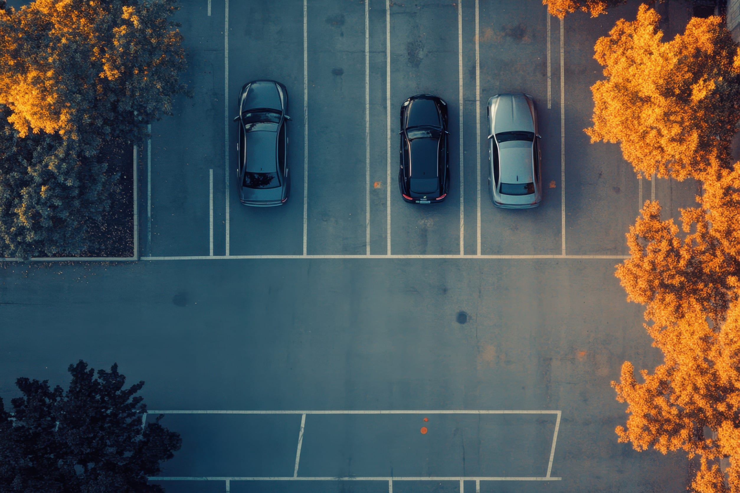 A few cars in a parking lot, the fees for which are often hidden by hotels in the fine print