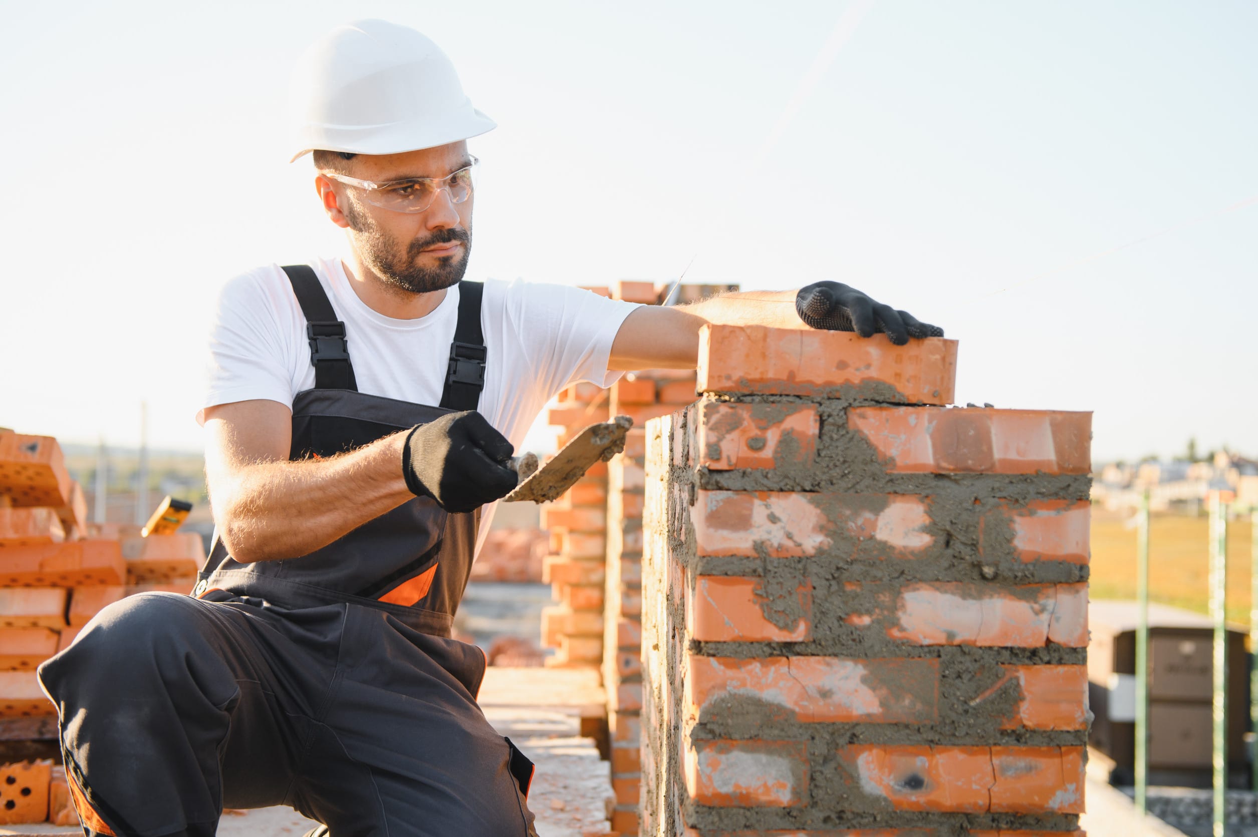 A builder working on putting together a chimney