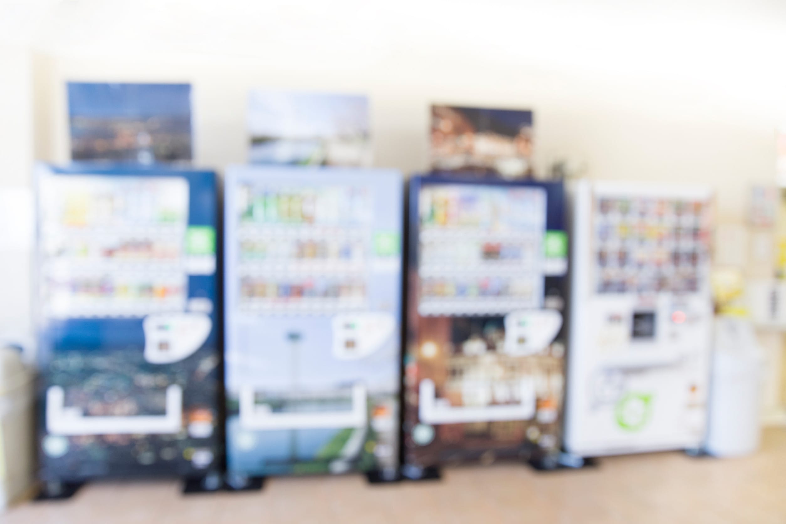 A blurry picture of vending machines, which an be a passive income scheme