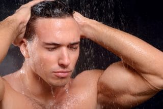 Handsome guy taking shower