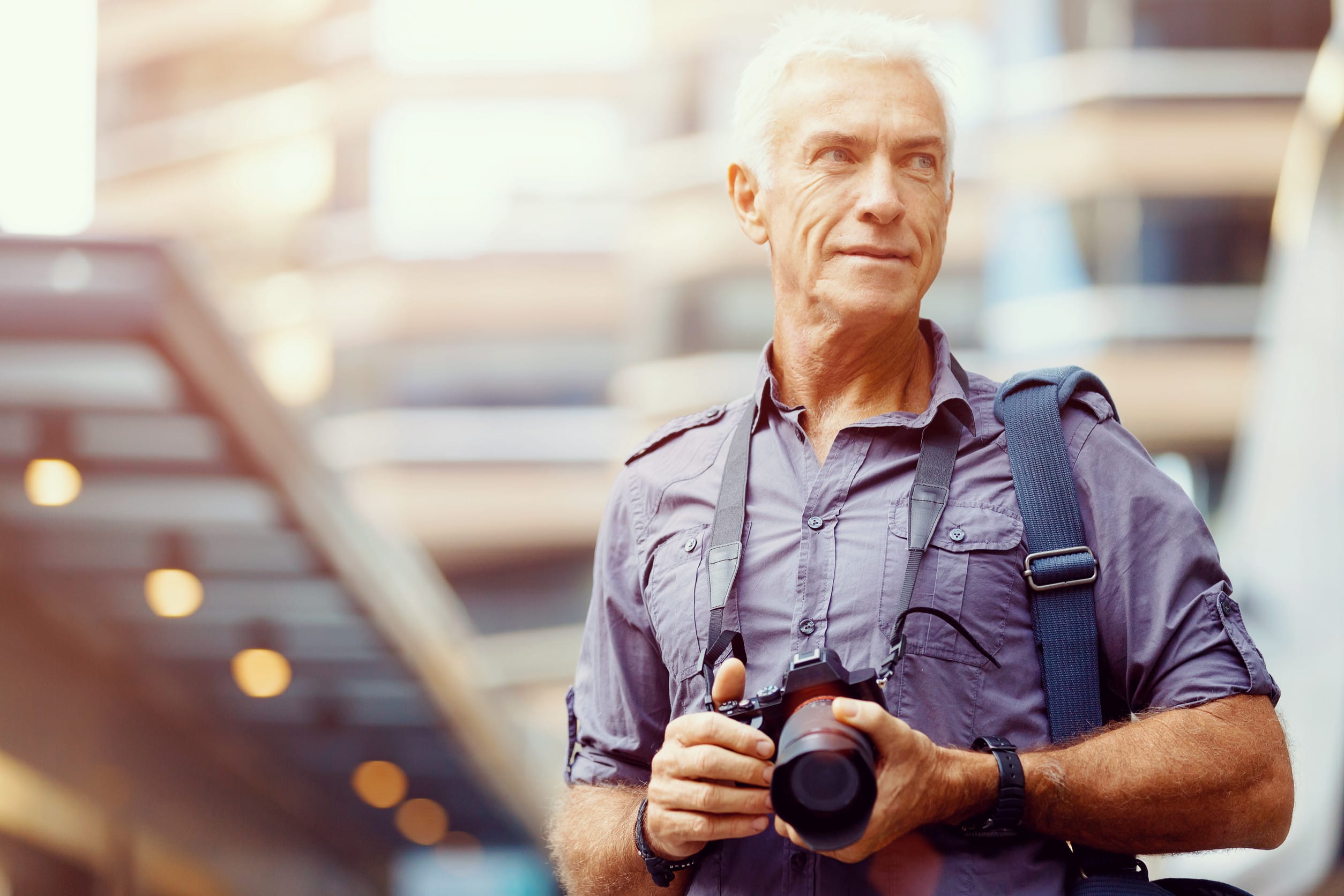older man holding a camera