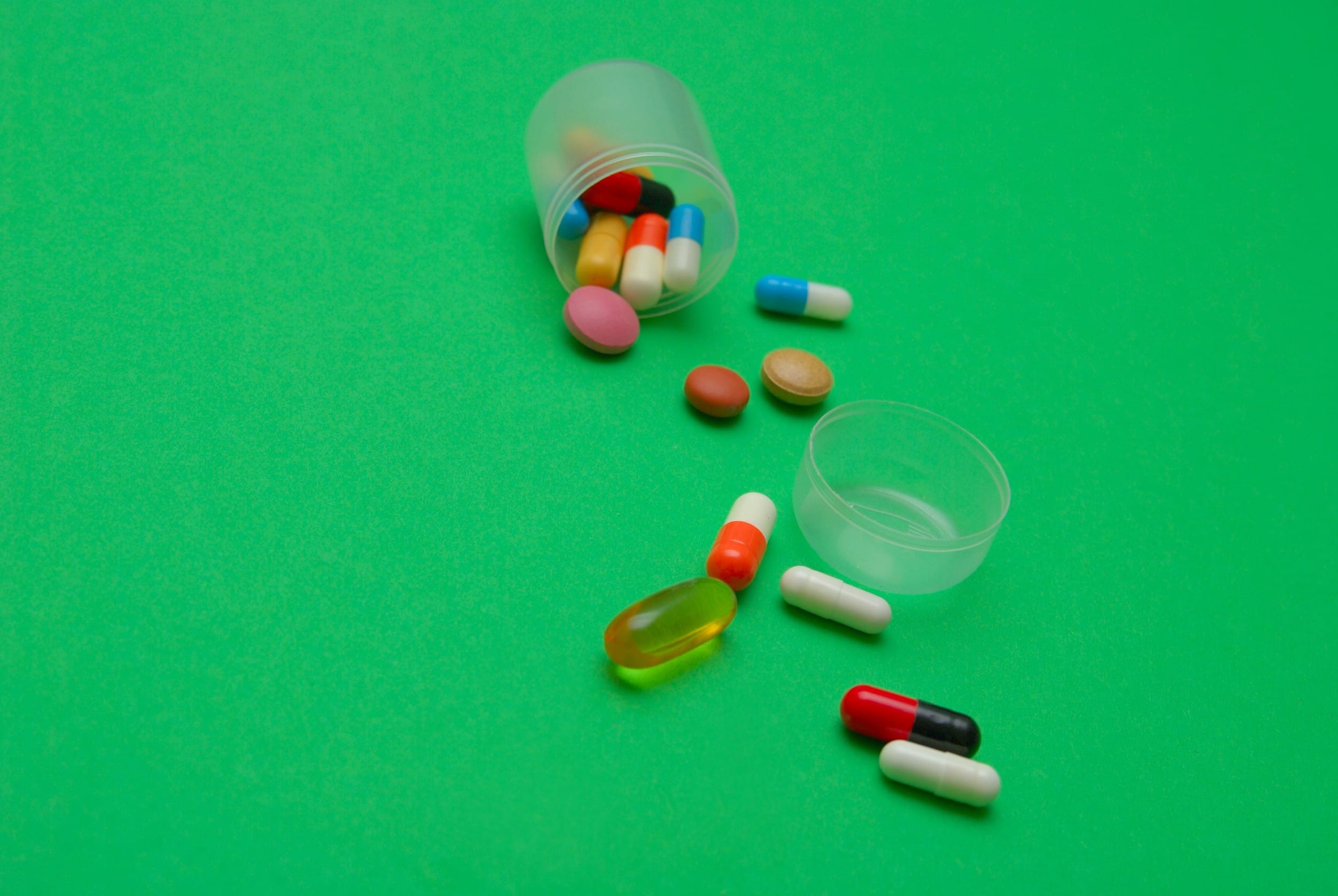Medications spilled on a green surface