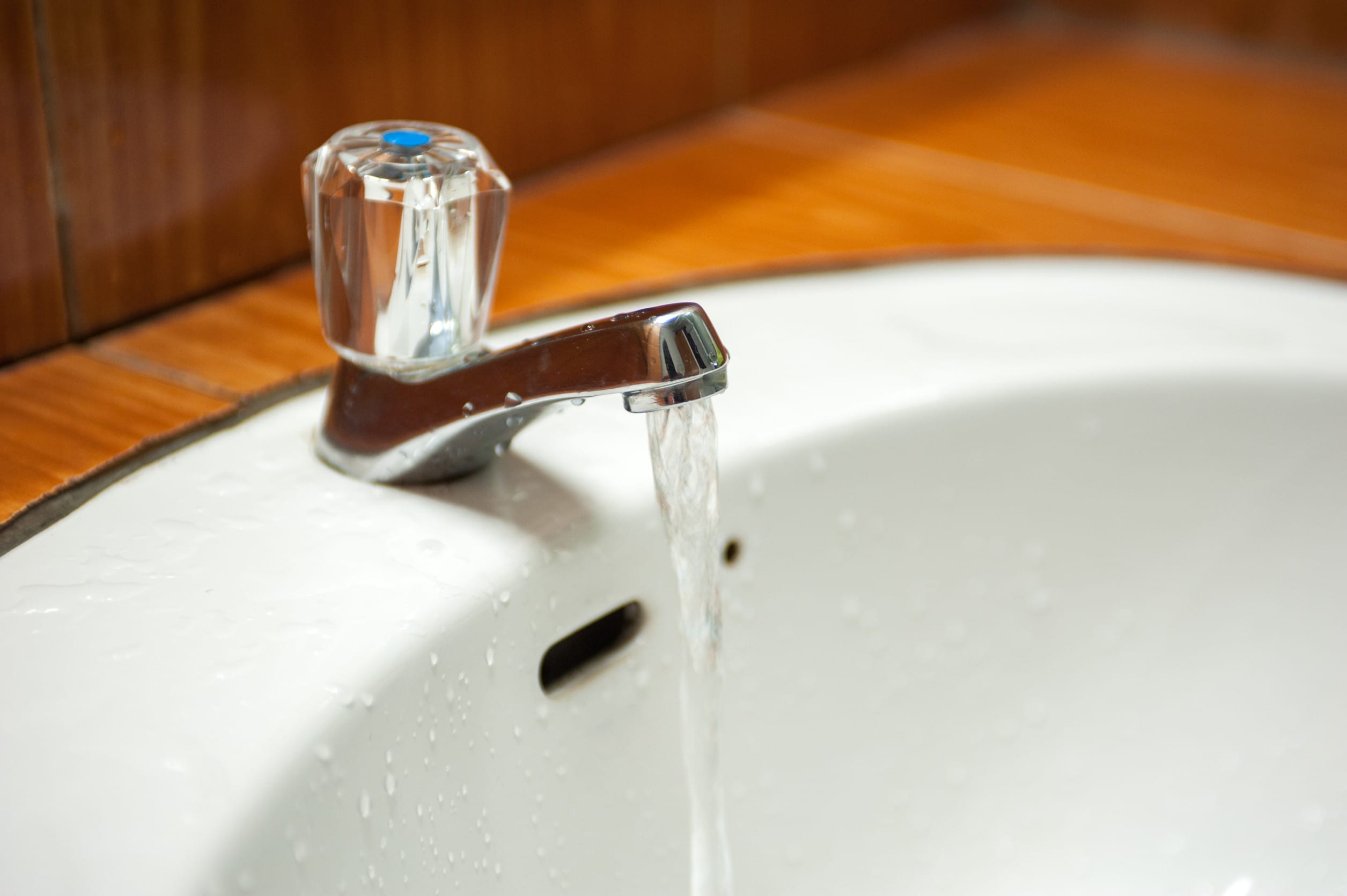 A faucet with tap water running