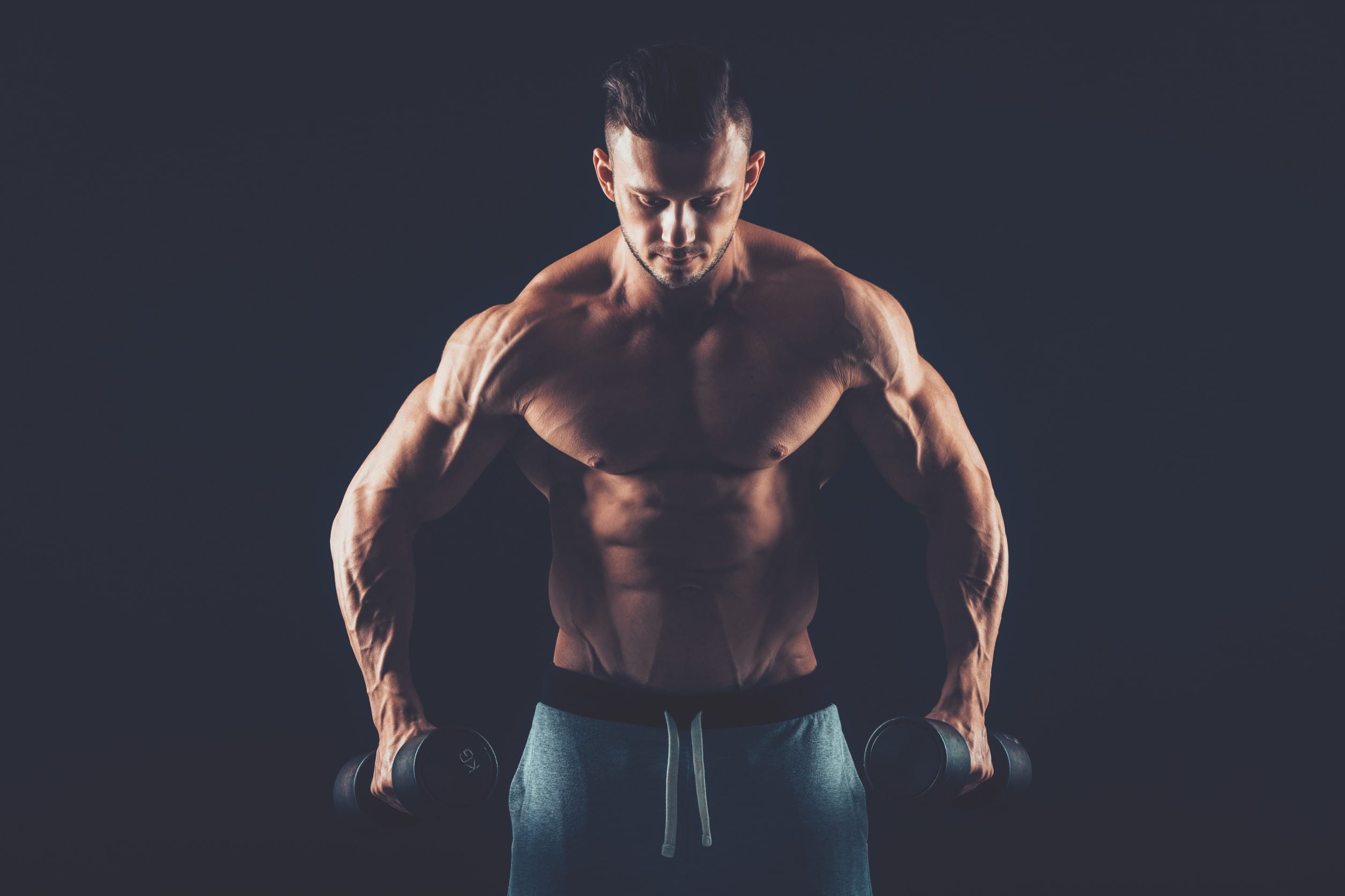 muscular topless man working out