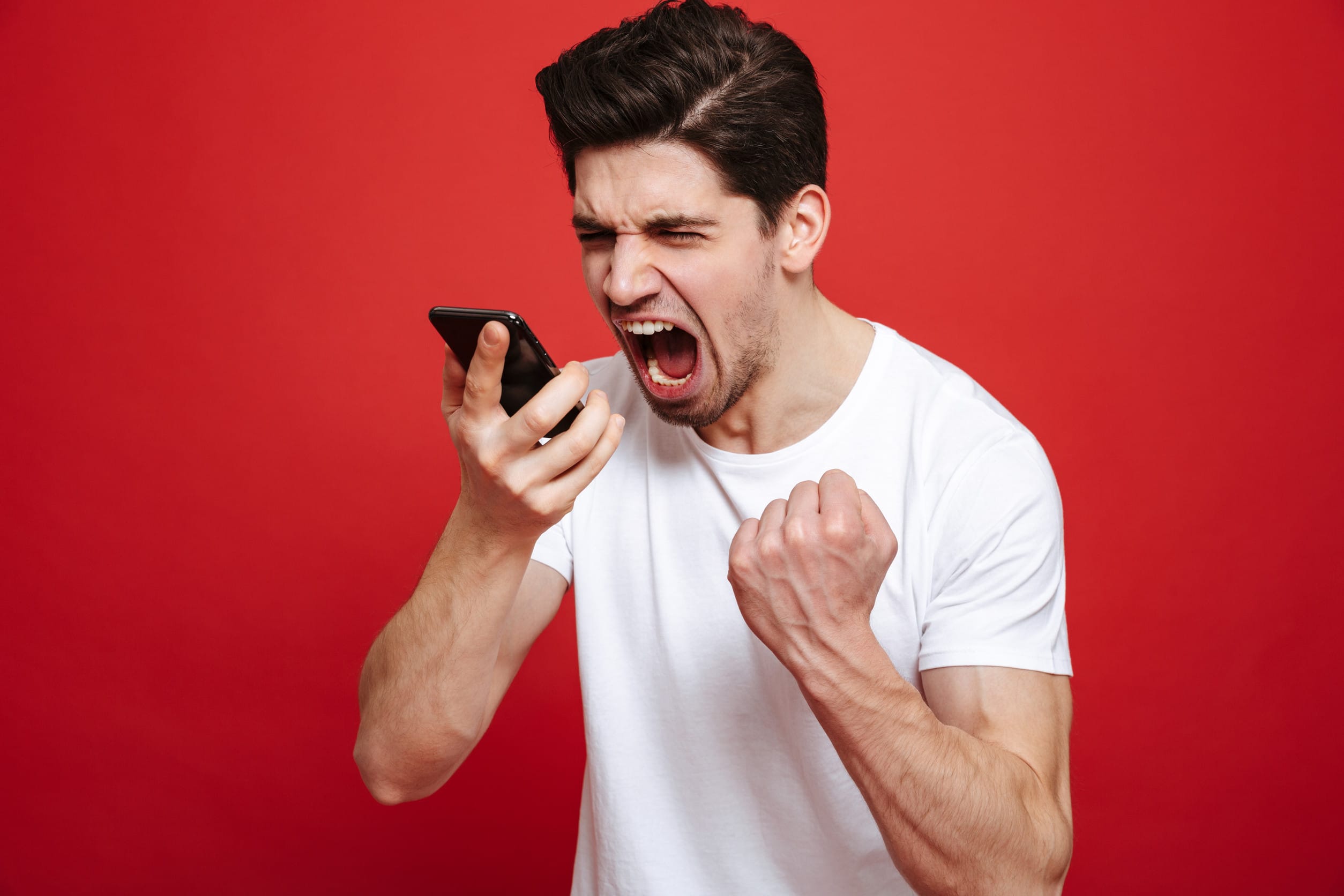 Angry man yelling into a phone