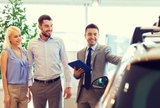 Young lady at dealership getting a car
