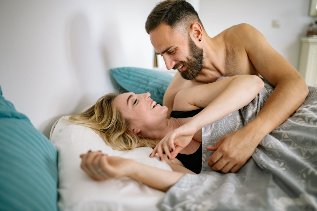 man and woman in bed